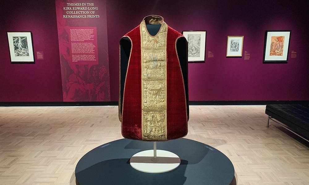 art exhibit with a close-up of an ornate Renaissance cape.