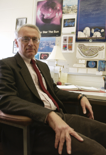 John Thomas seated in his office.