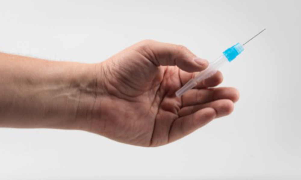 Feature image close-up of hand holding a small syringe.