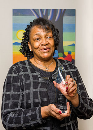 Precious Bedell holding award