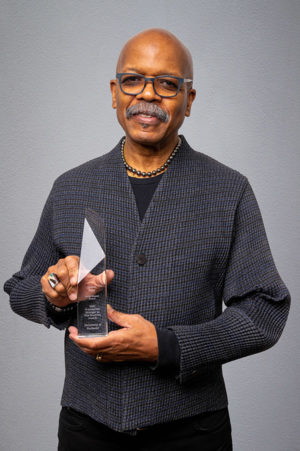 Carvin Eison holds award
