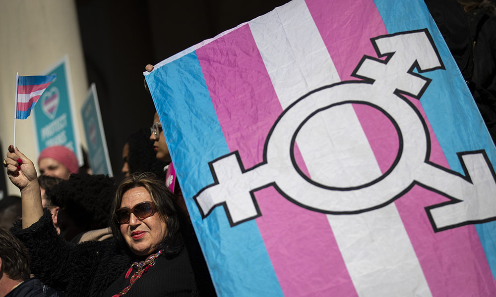 Feature image protester holding a transgender pride flag