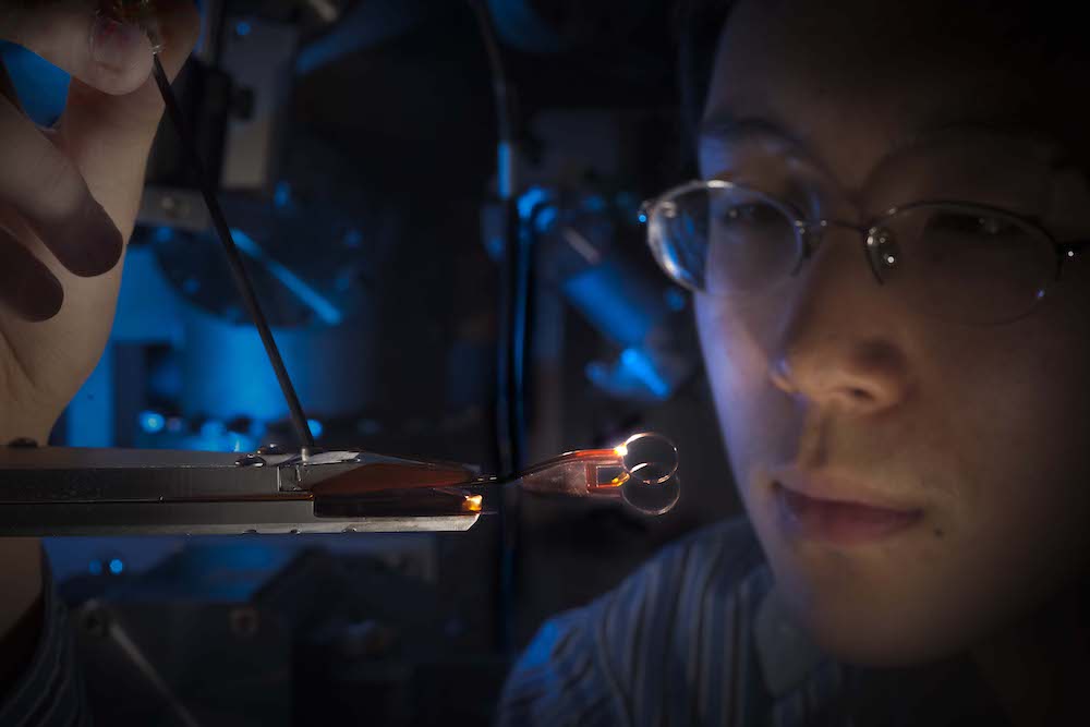 close up of student touching a stick to a device