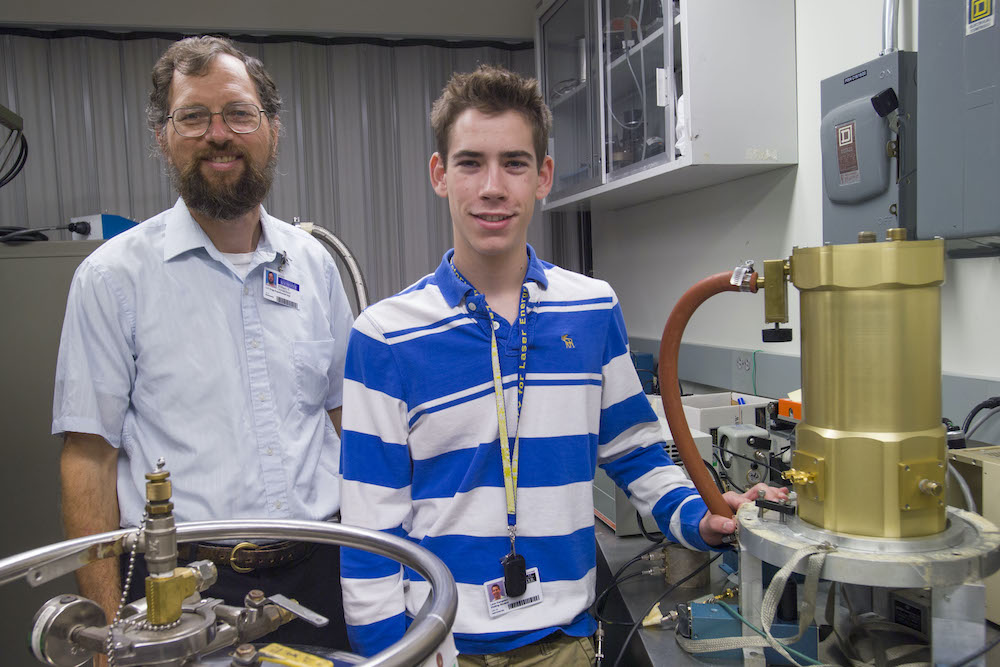 professor and student stand side by side in lab