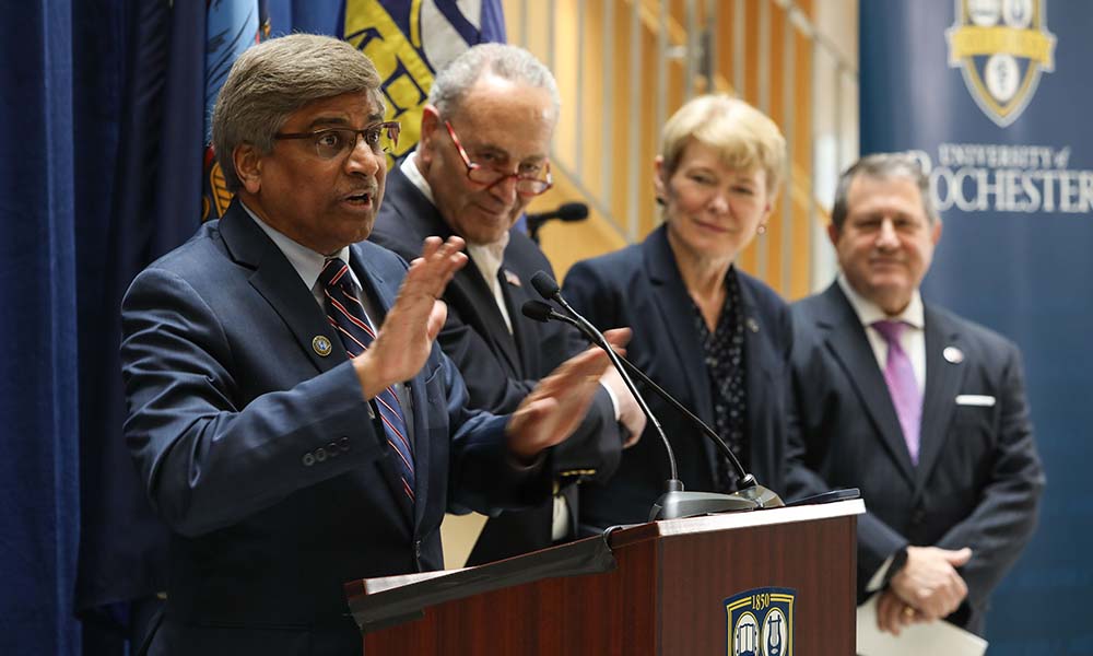 NSF director Panchanathan speaks at podium, with Sen. Schumer, University President Mangelsdorf, and Rep. Morelle standing in line to his left.