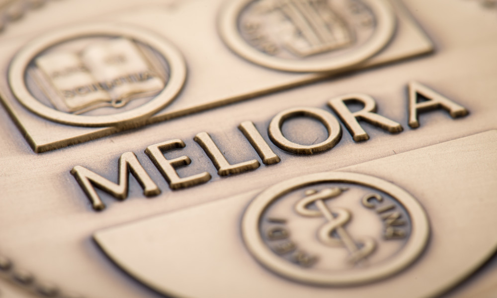 Closeup of a medal bearing the University of Rochester seal.