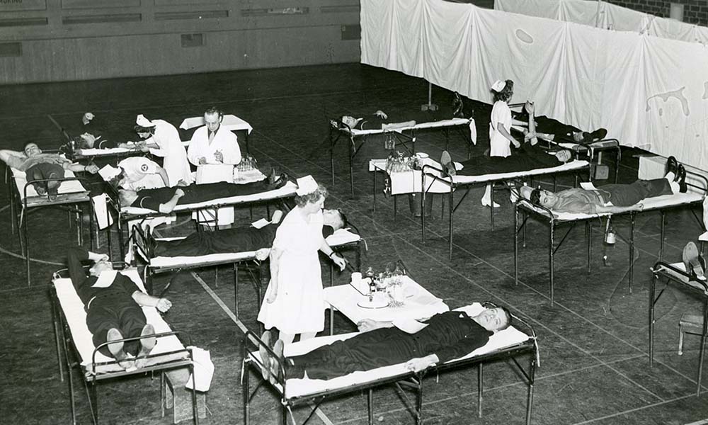 Feature image Nurses in Palestra attend to students on cots at blood drive.