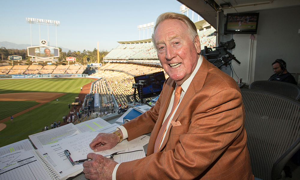 Feature image archival photo of Vin Scully in the broadcast booth.