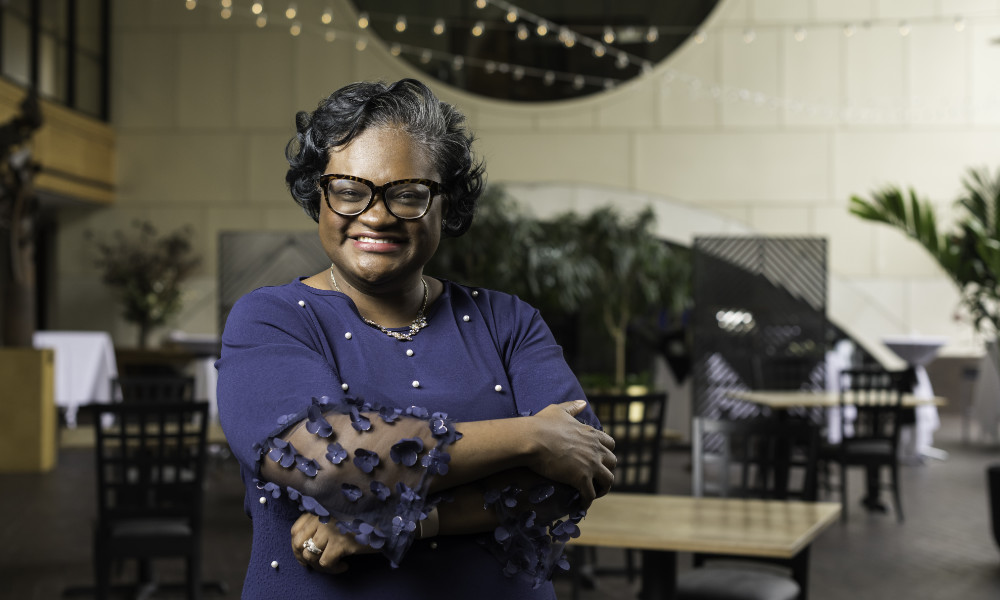 Crystal Sellers Battle with her arms crossed in the Eastman School of Music's Miller Center.