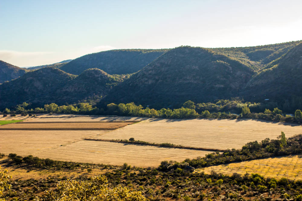 Farms in the Vredefort crater with the dome in the background.