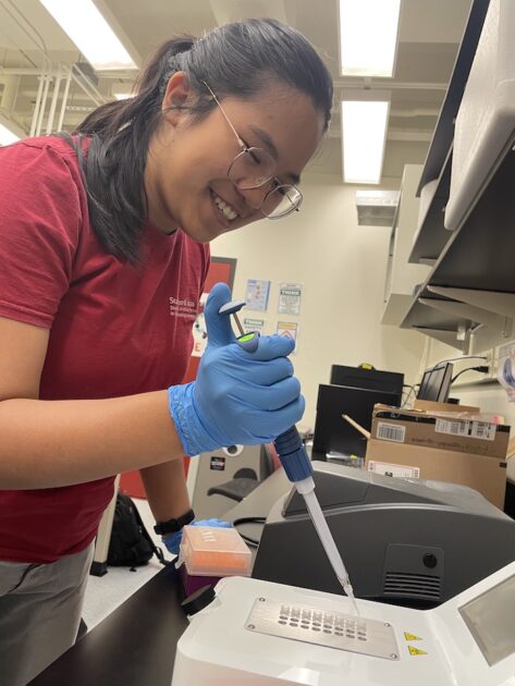 An Vo holds a syringe-like device over EMnetik machine.