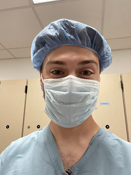 student in medical scrubs and mask.