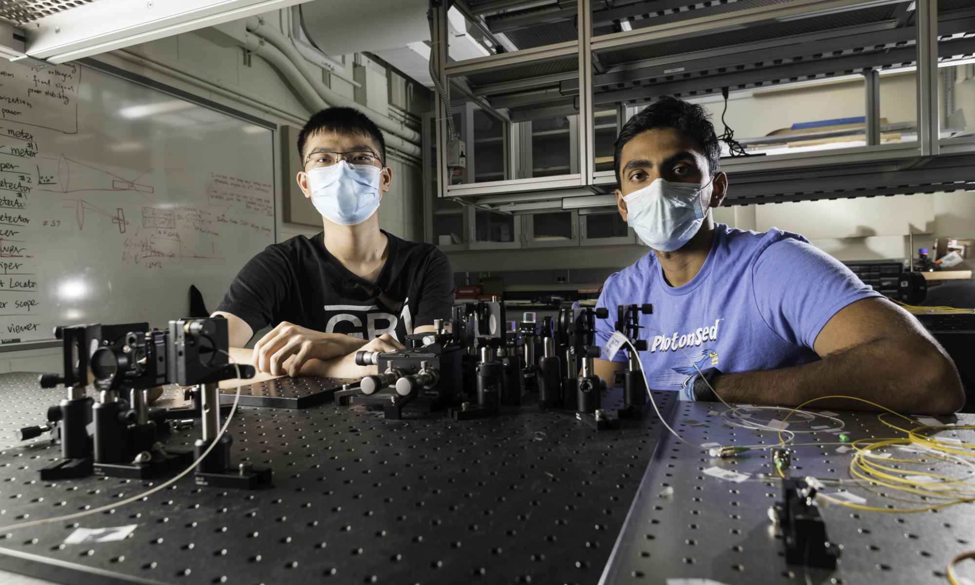 Optics students wearing masks in a lab.