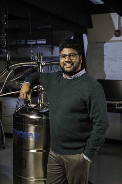 Ranga Dias, whose research focuses on creating superconducting materials, leans on his lab equipment.