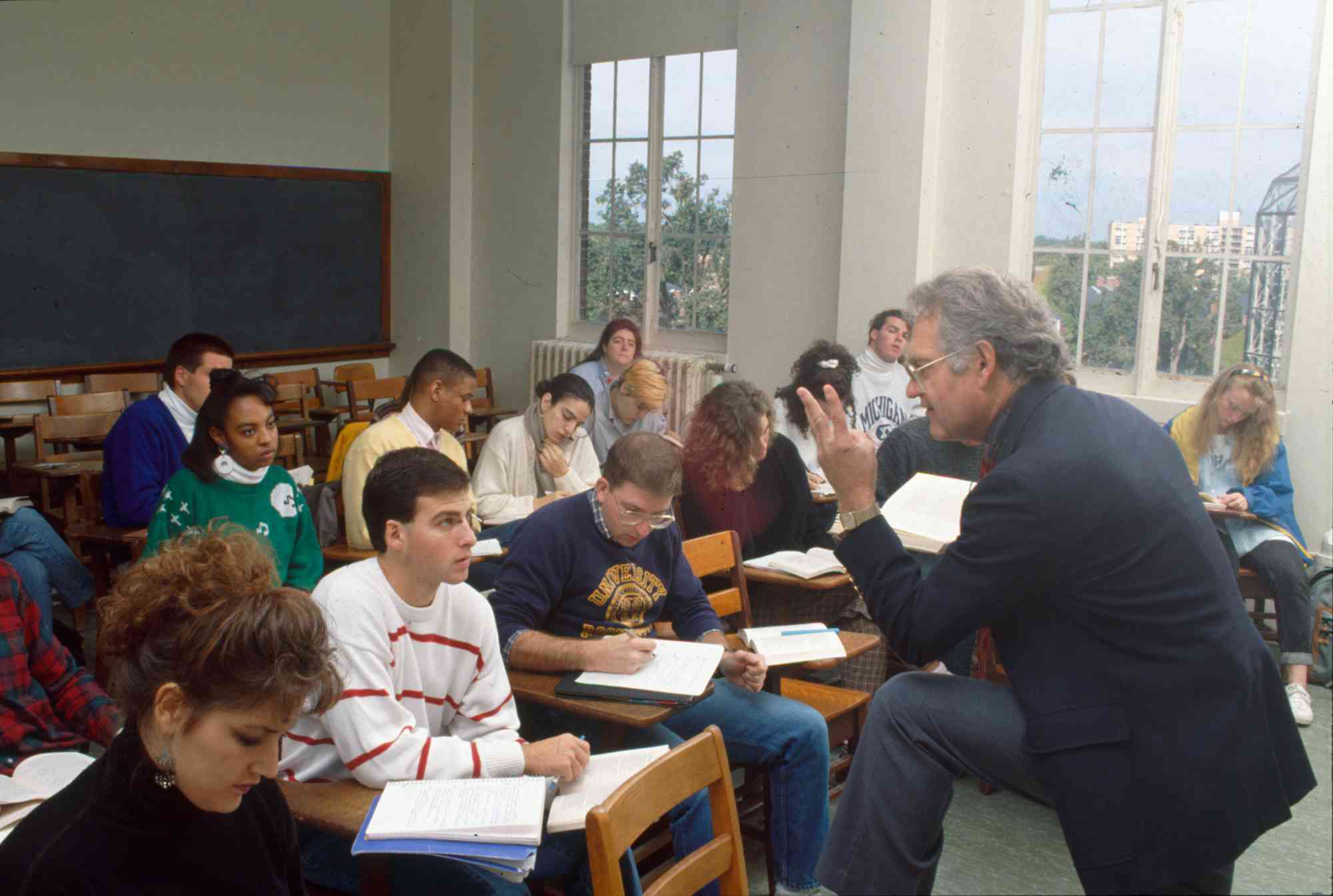 Color photo of Russell Peck teaching in a classroom at the University of Rochester.