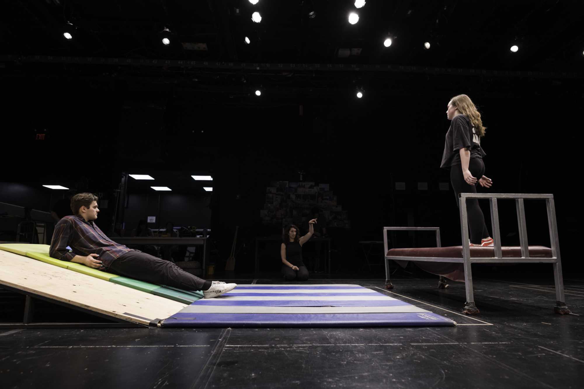 Intimacy director Sara Penner gives two theater students feedback during a rehearsal.