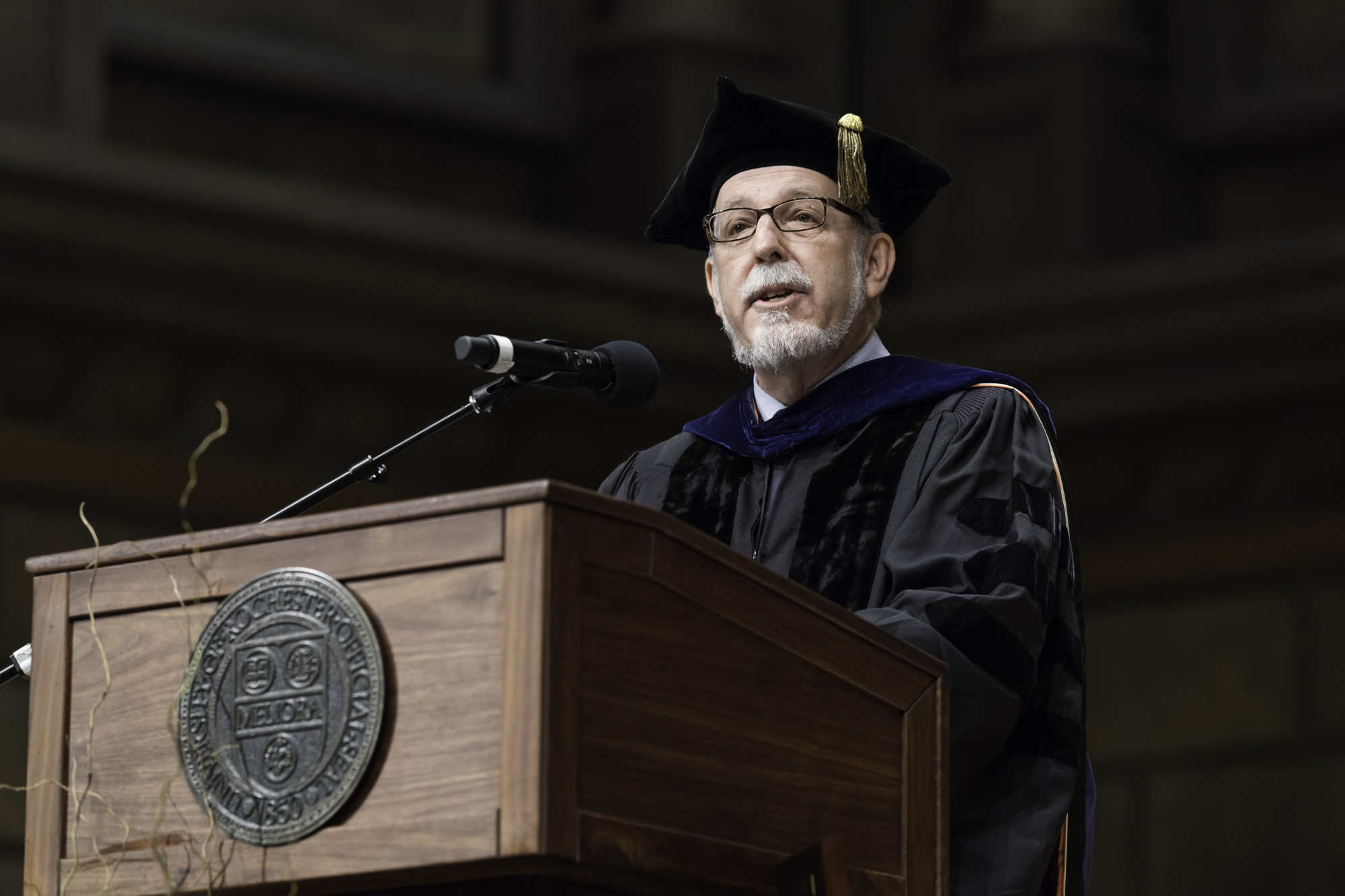 William Jones in regalia at the podium during the University of Rochester Commencement.