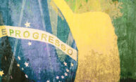 Close-up of the Brazilian flag with the focus on the word PROGRESSO against a rough surface.