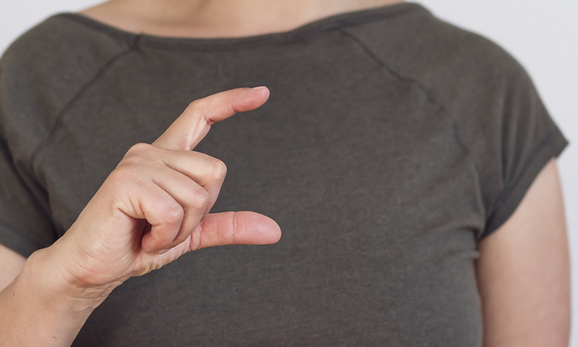 Woman's hand making gesture used in test for Parkinson's disease.