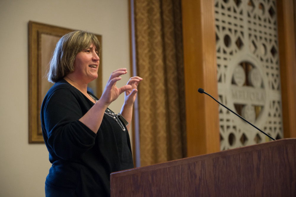 Julie Bentley gestures at a podium.