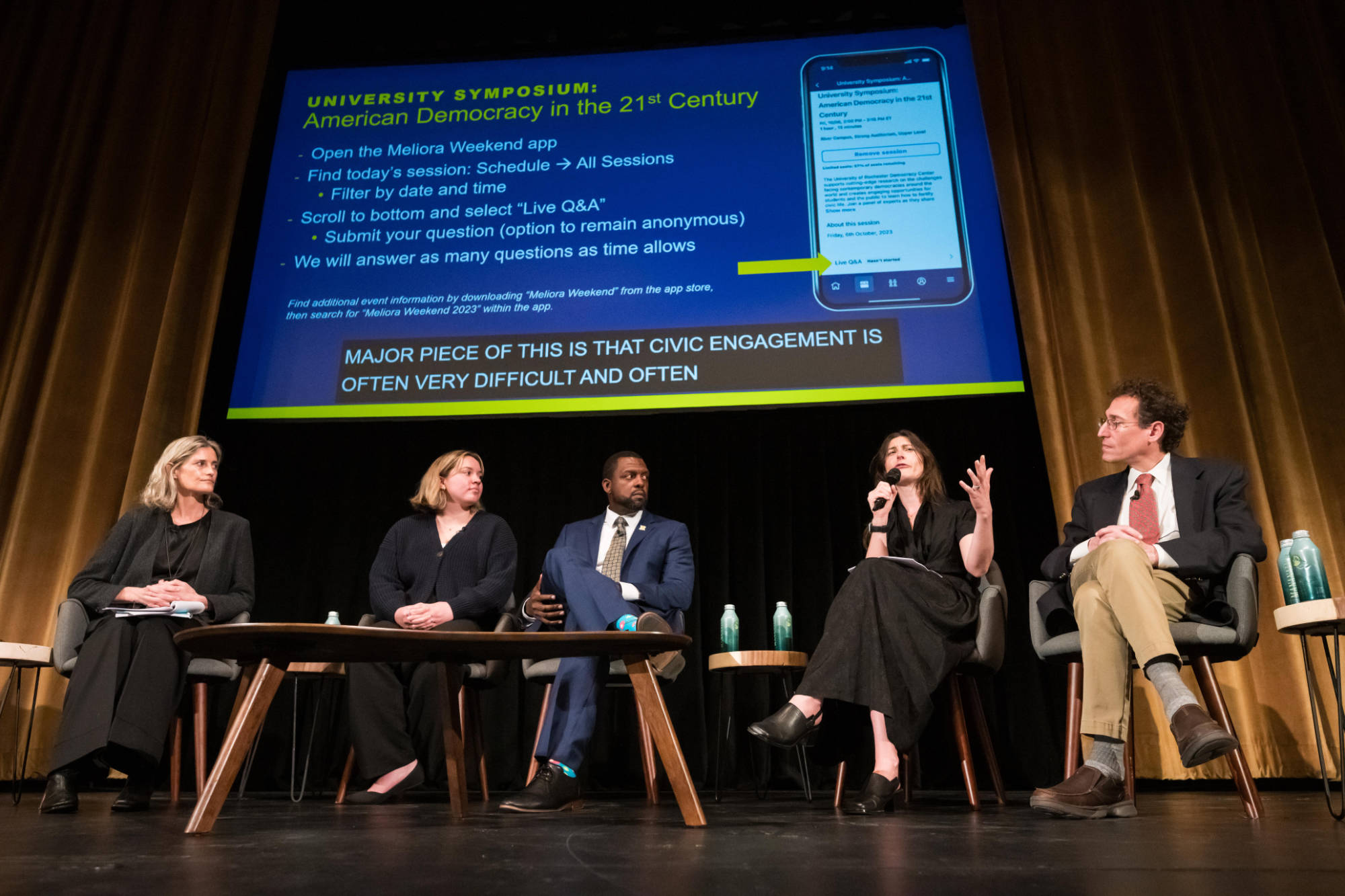 Five University of Rochester experts on stage during a Meliora Weekend 2023 symposium.