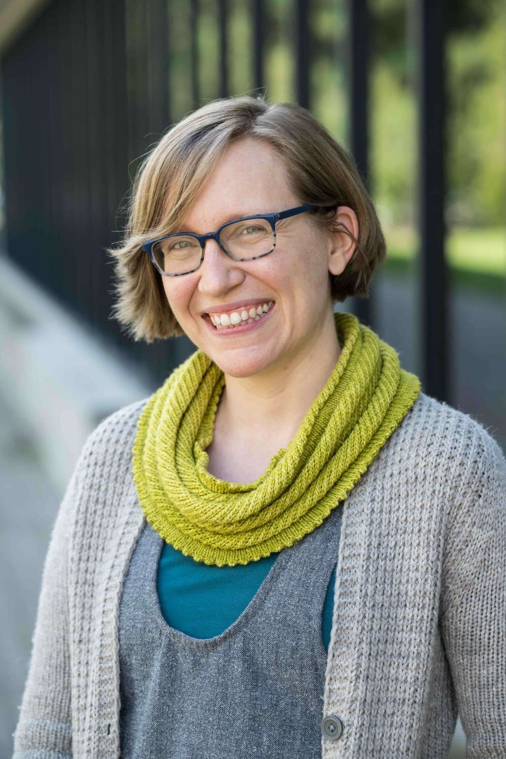 Portrait of Whitney Gegg-Harrison outdoors and smiling at the camera.