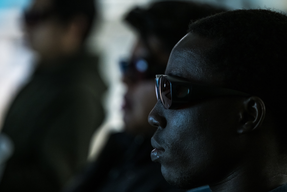 Students in profile in 3-D glasses