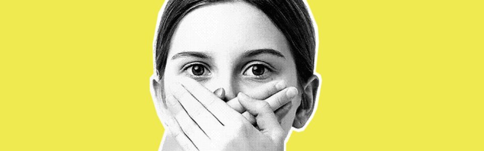 photo of a young person holding their hands over their mouth like the have a secret they don't want to tell.