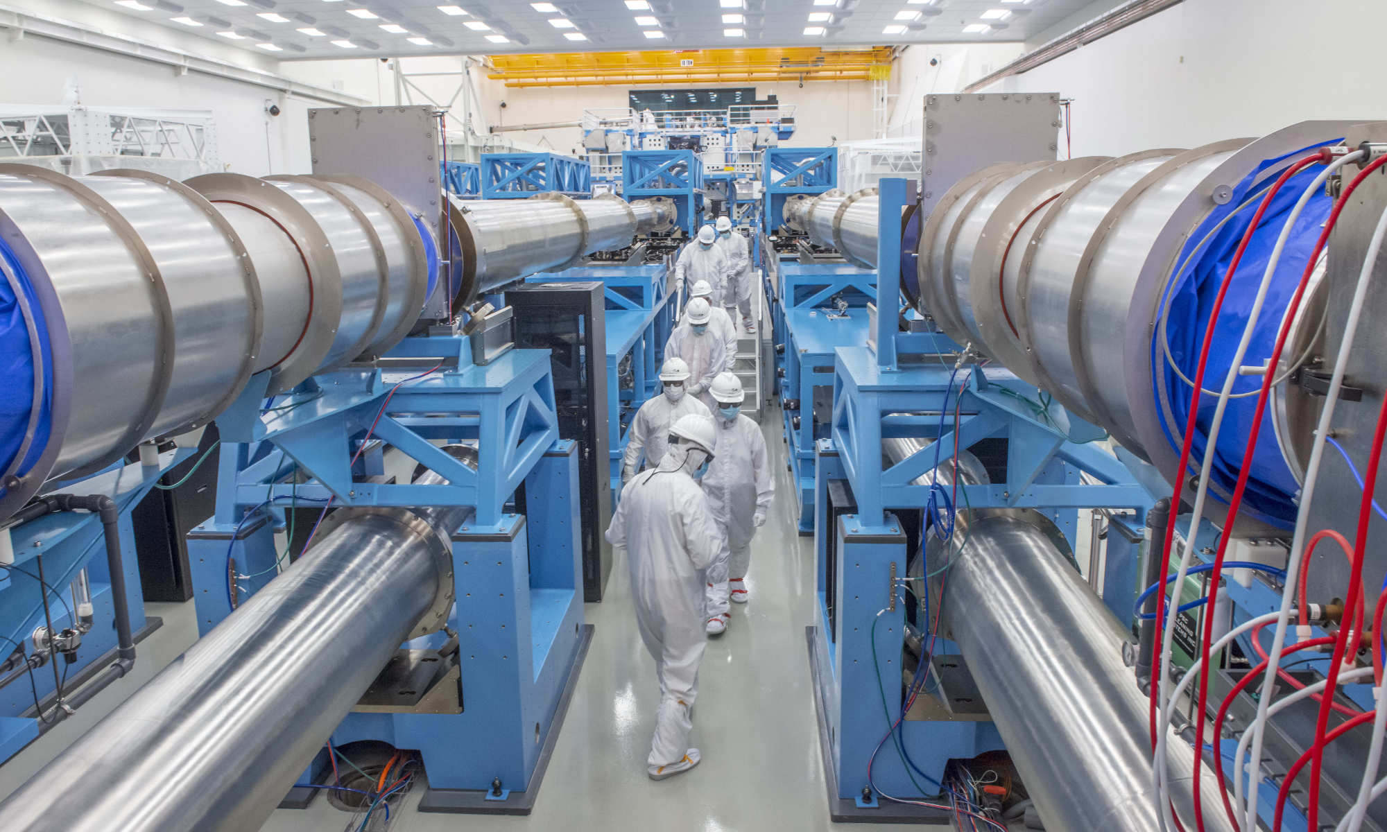 Laser Lab visitors and staff in white safety gear tour the OMEGA EP Target Bay.