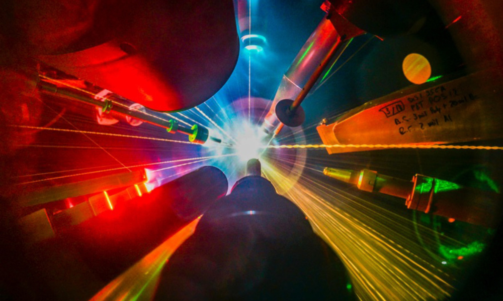 Multiple lasers pointing and shooting at a target during a direct-drive inertial fusion experiment.