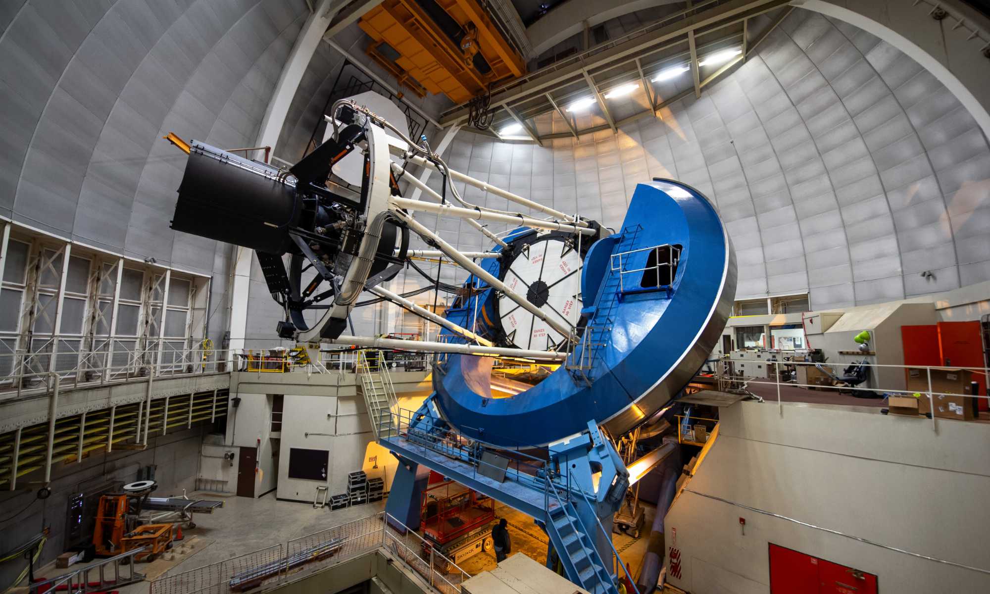 Side view of the Dark Energy Spectroscopic Instrument, used to detect dark energy and map the expanding universe, atop a large telescope.