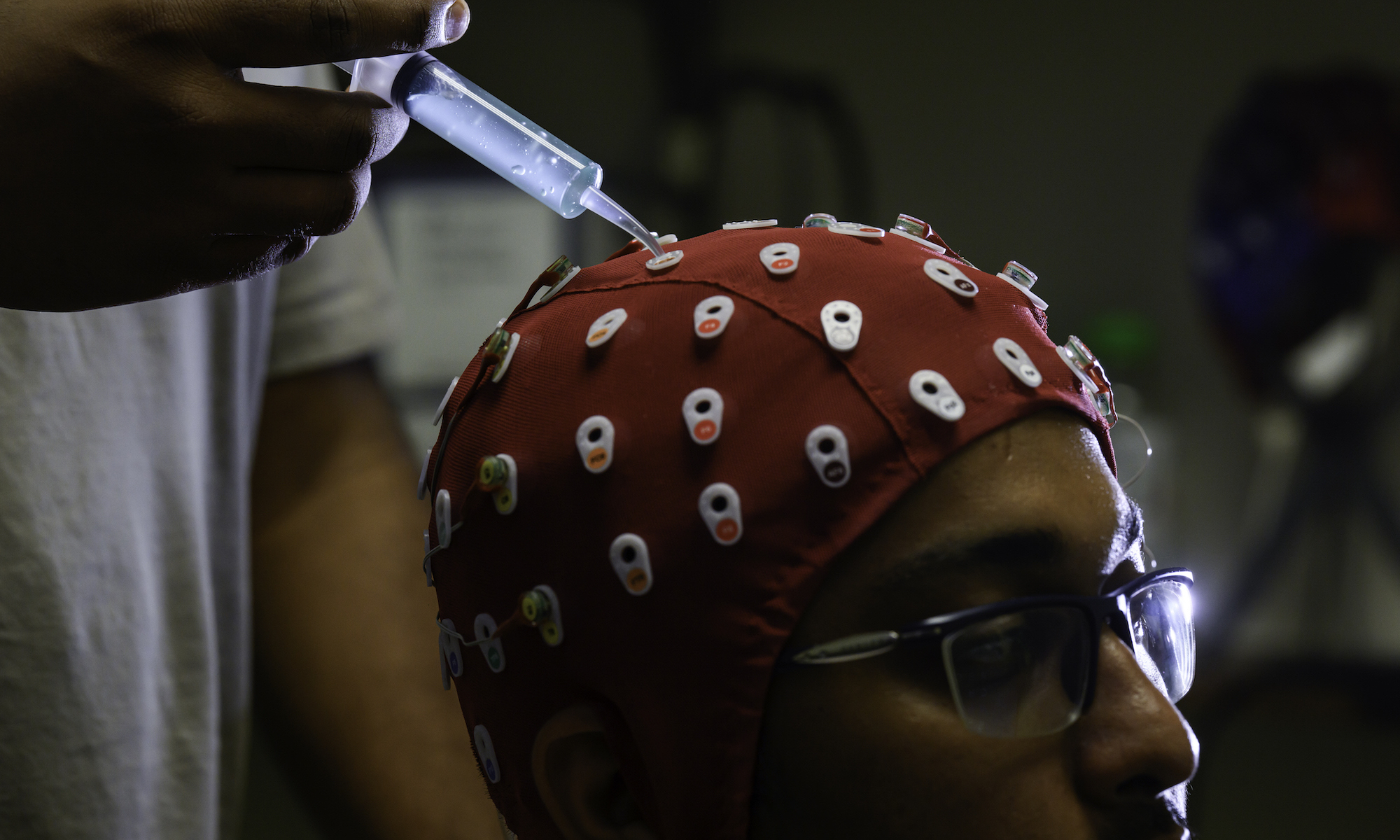 Biomedical engineering PhD student Fazla Mashrur wears an electroencephalography cap during an experiment.