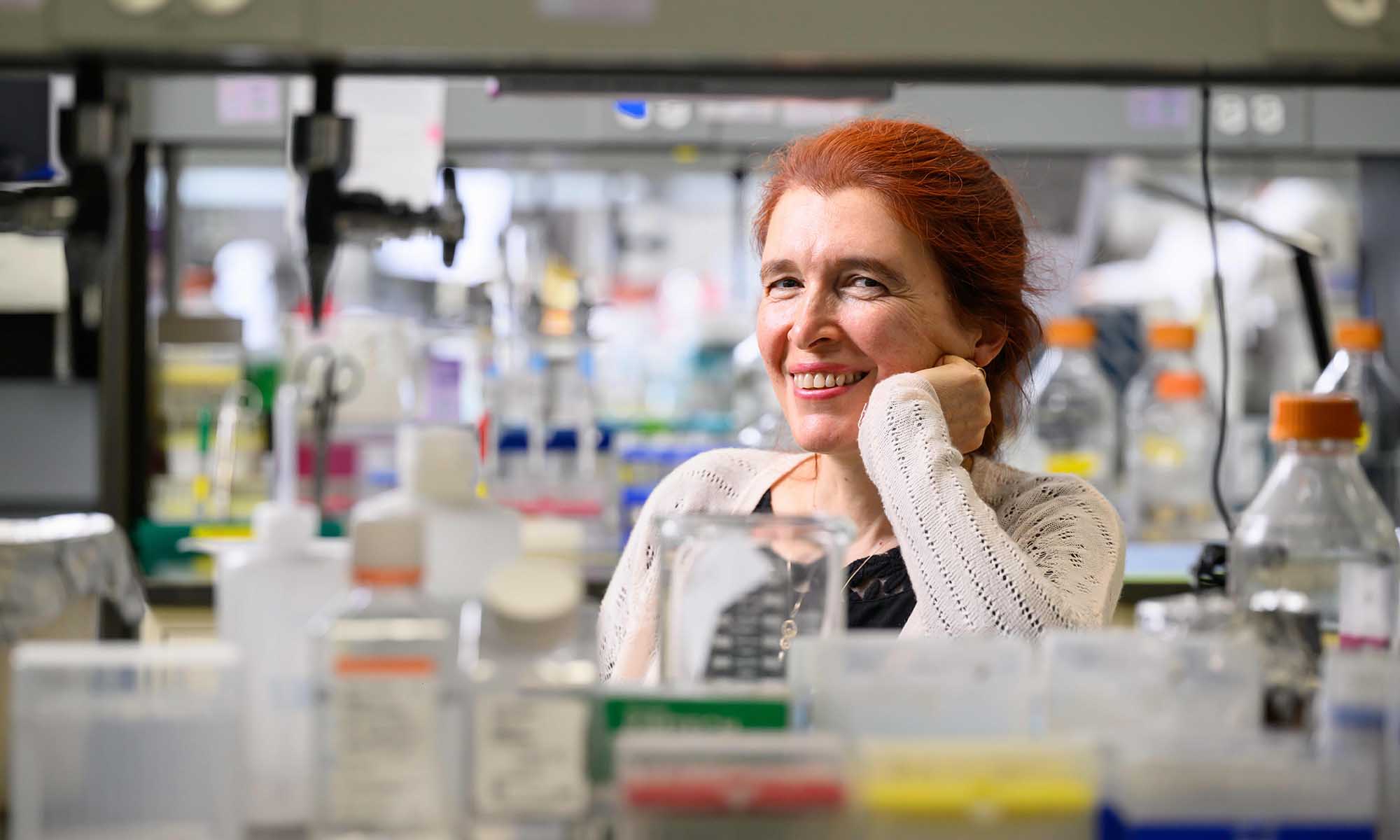 Vera Gorbunova smiles at the camera in her biology lab in Hutchison Hall.