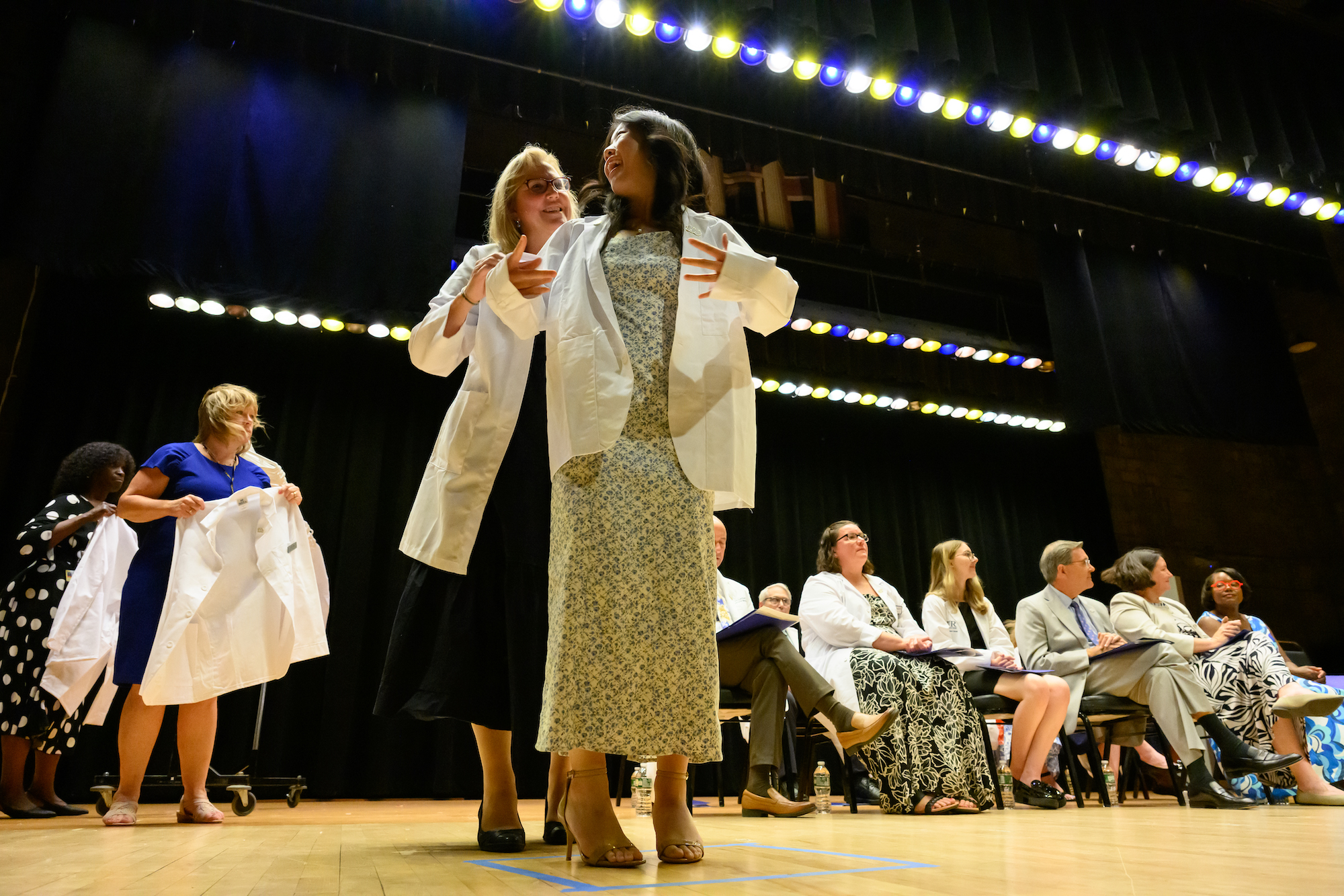 A first-year medical student receives her white coat at the annual ceremony.