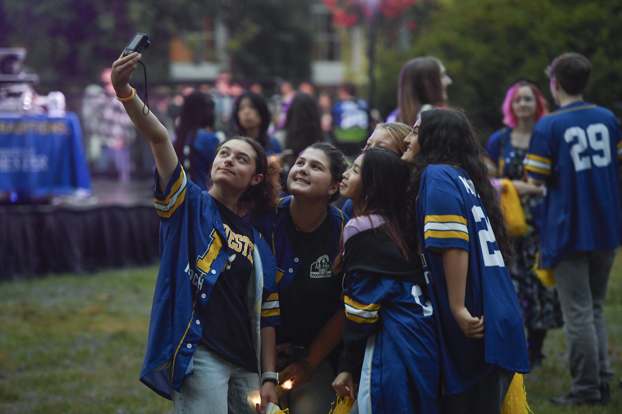 Students pose for a selfie in University of Rochester jerseys.