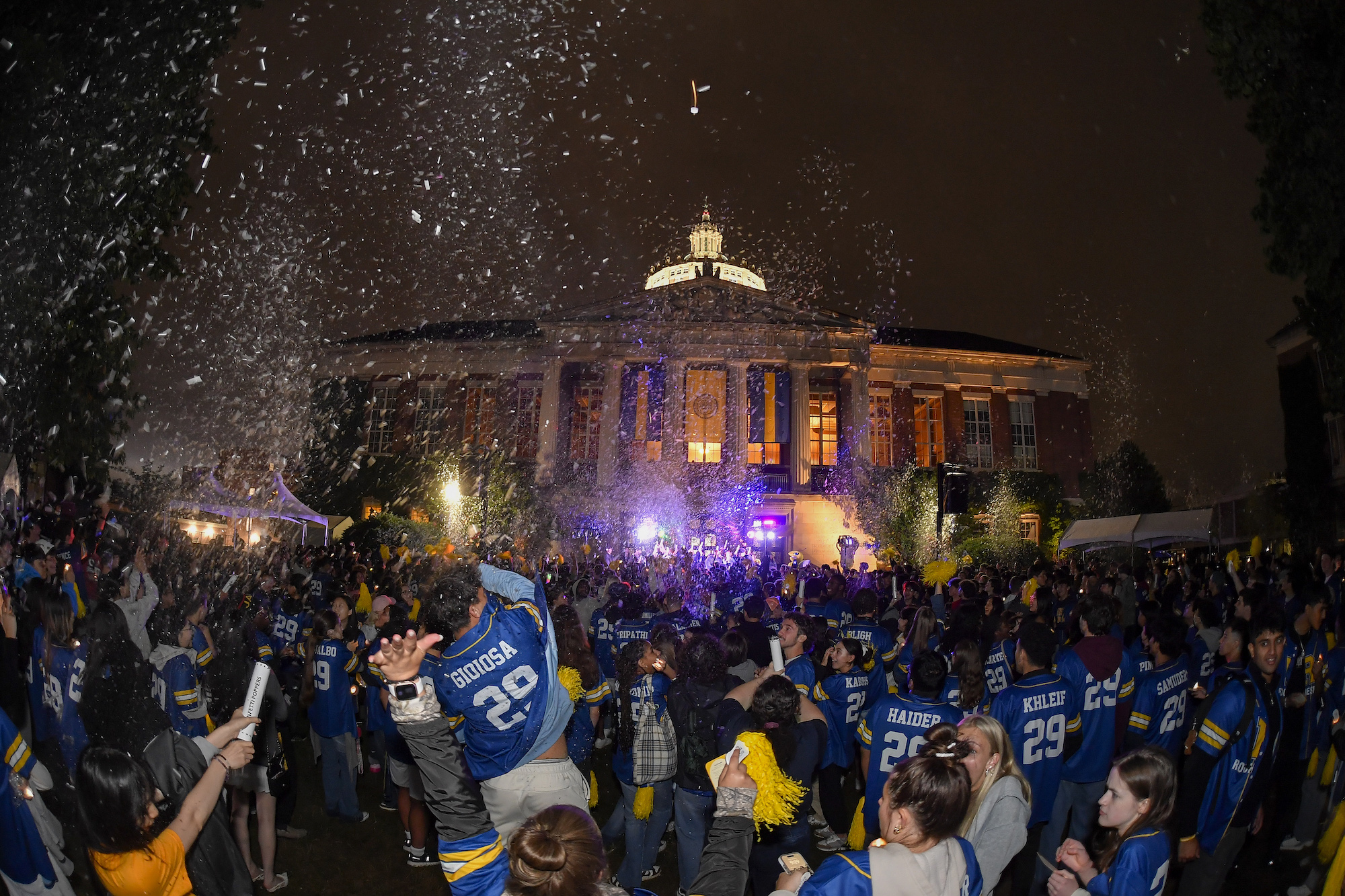 Confetti and uplighting decorate the Candlelight Ceremony.