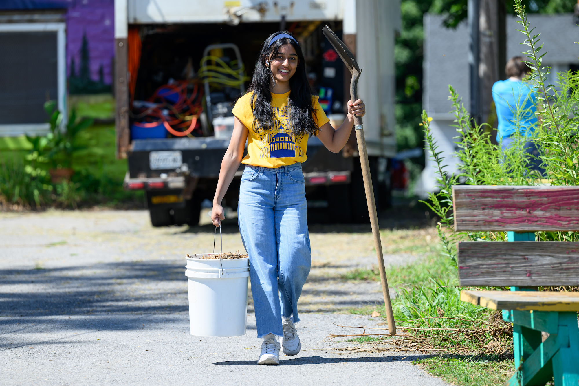 Lubna Shah ’28, a D’Lion, carries mulch at the Gandhi Institute for Nonviolence during Wilson Day.