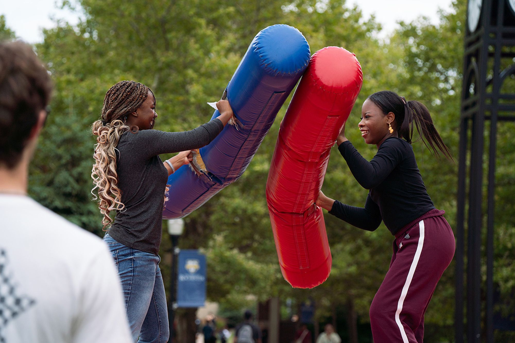 Two students battle with inflatable batons during Field Day.