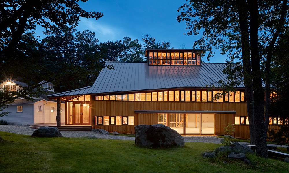 Nighttime exterior view of a Jacob's Pillow dance studio.