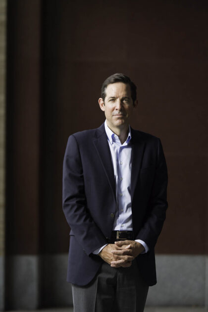 Portrait of Tom Farrell standing and looking at the camera.