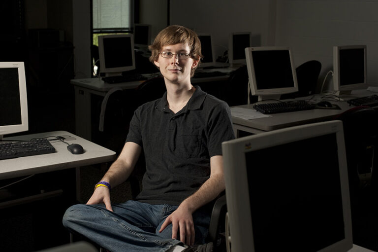 Chase Hermsen poses for a portrait in a URochester computer lab in 2010.