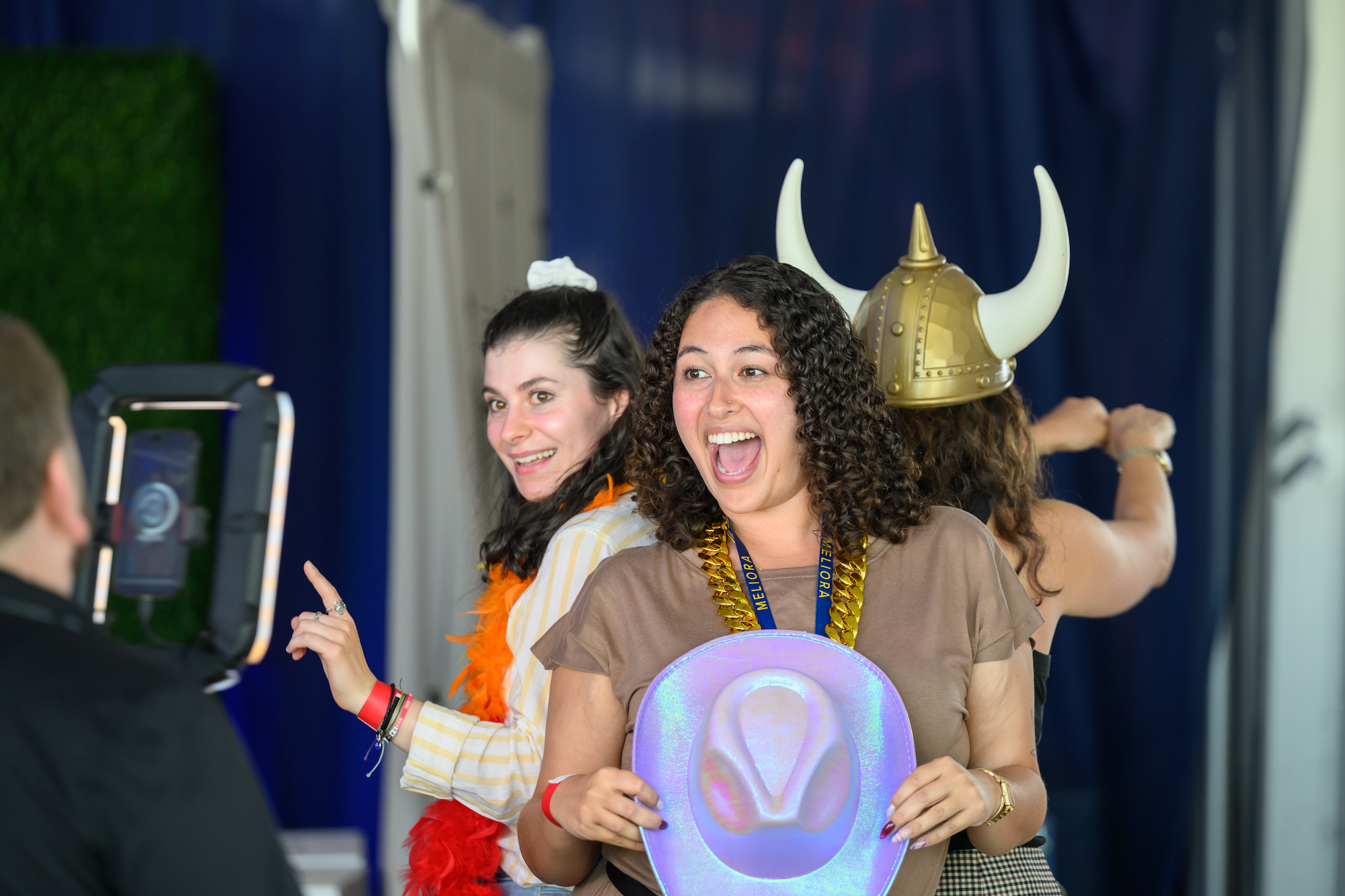 Students use props as part of a 360 selfie machine. 
