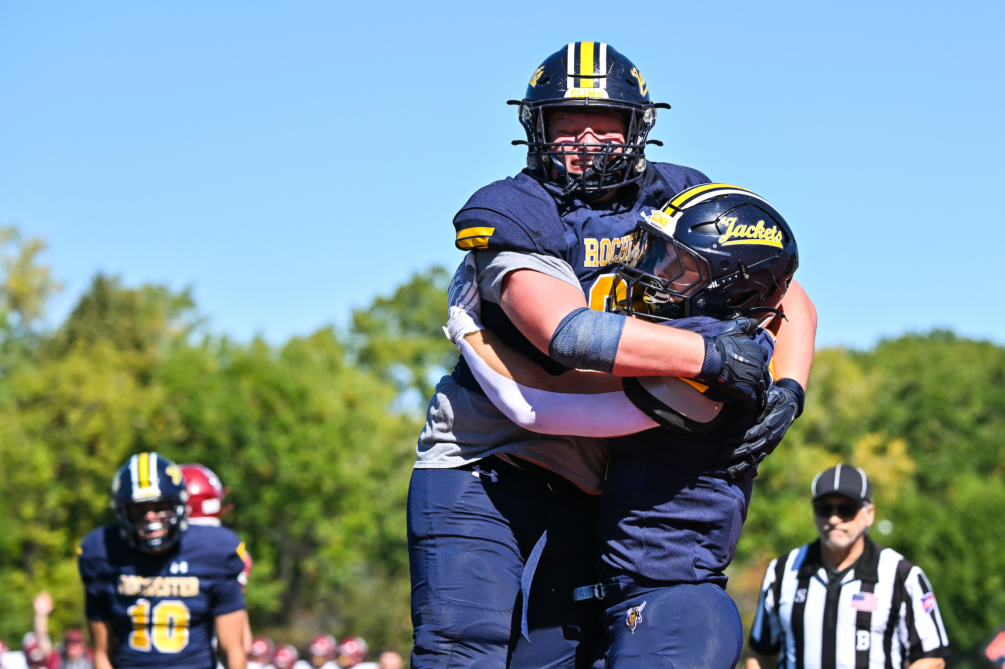 Two Rochester football players celebrate.