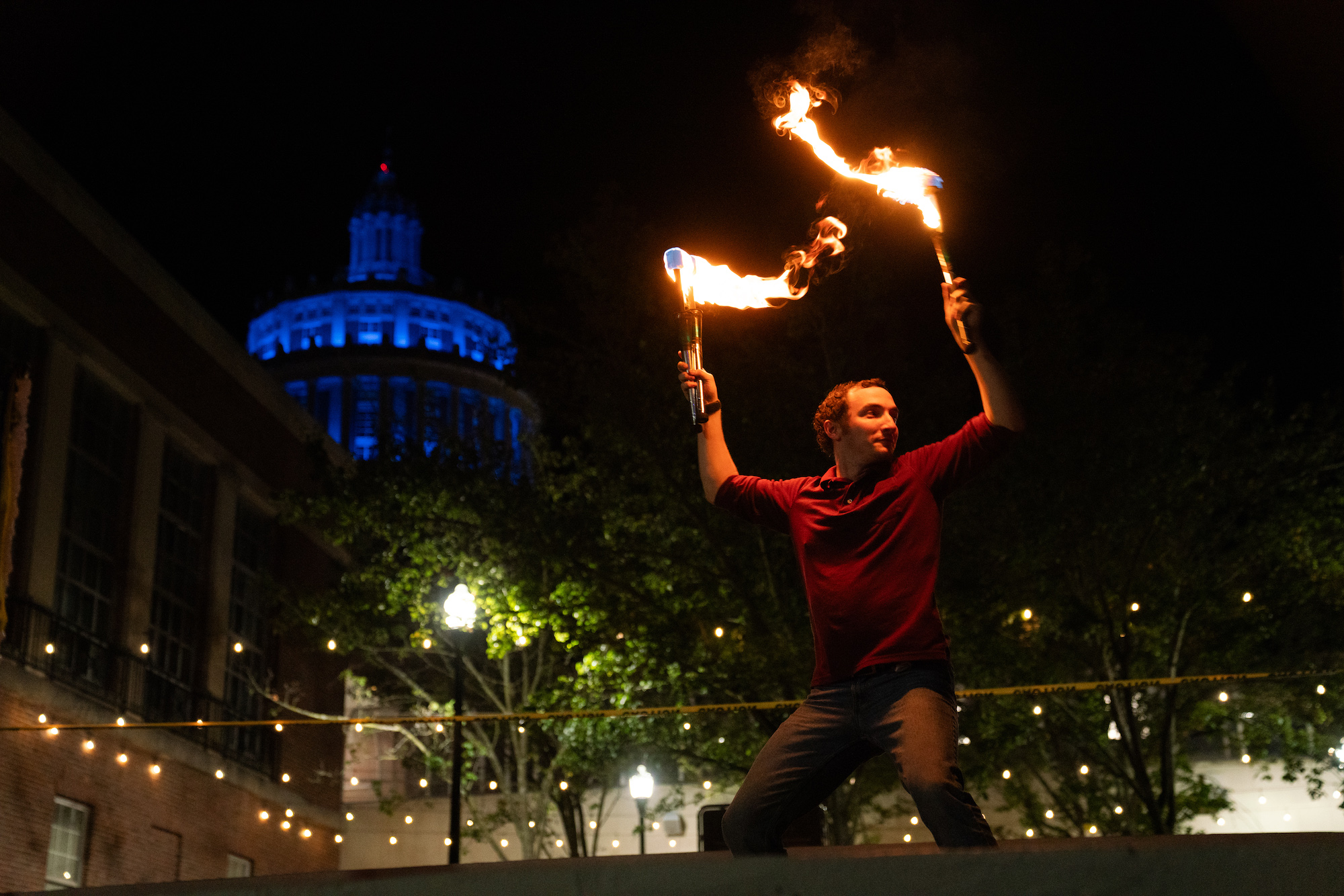 The Strong Jugglers perform a nighttime show with flaming sticks.