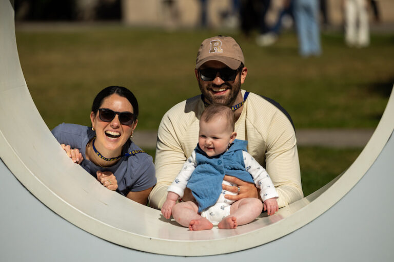 Parents and a baby pose in the Meliora 
