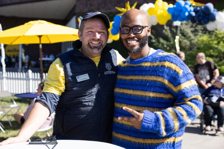 Attendees pose for a photo in Meliora Village.
