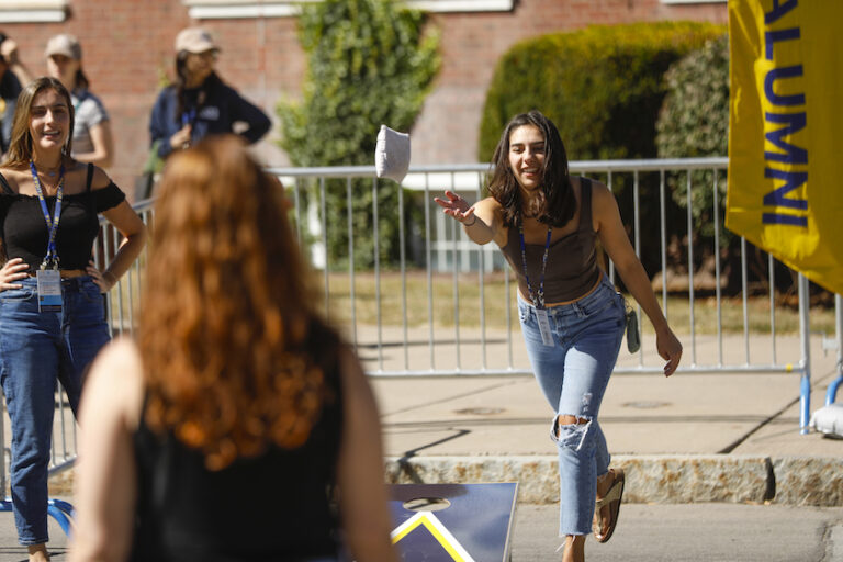 A woman plays cornhole.