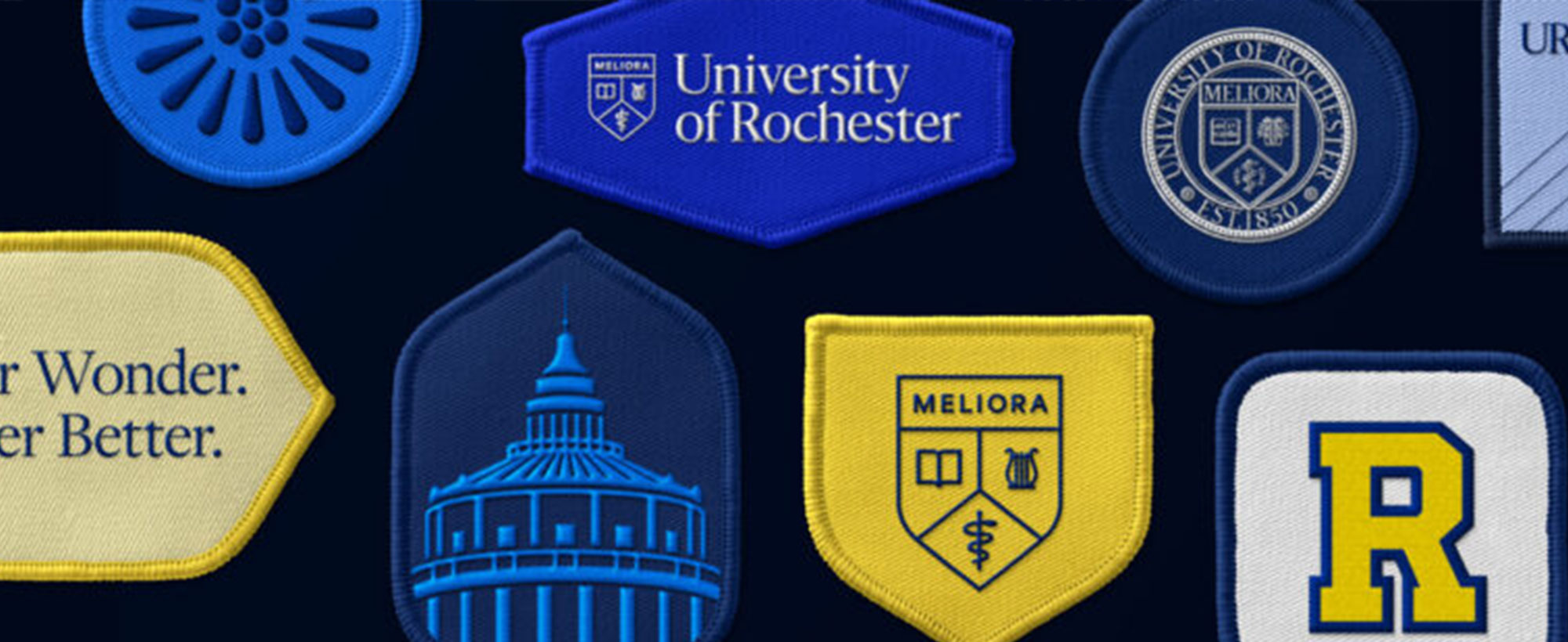 Close-up of various patches featuring the new University of Rochester brand logos and icons.