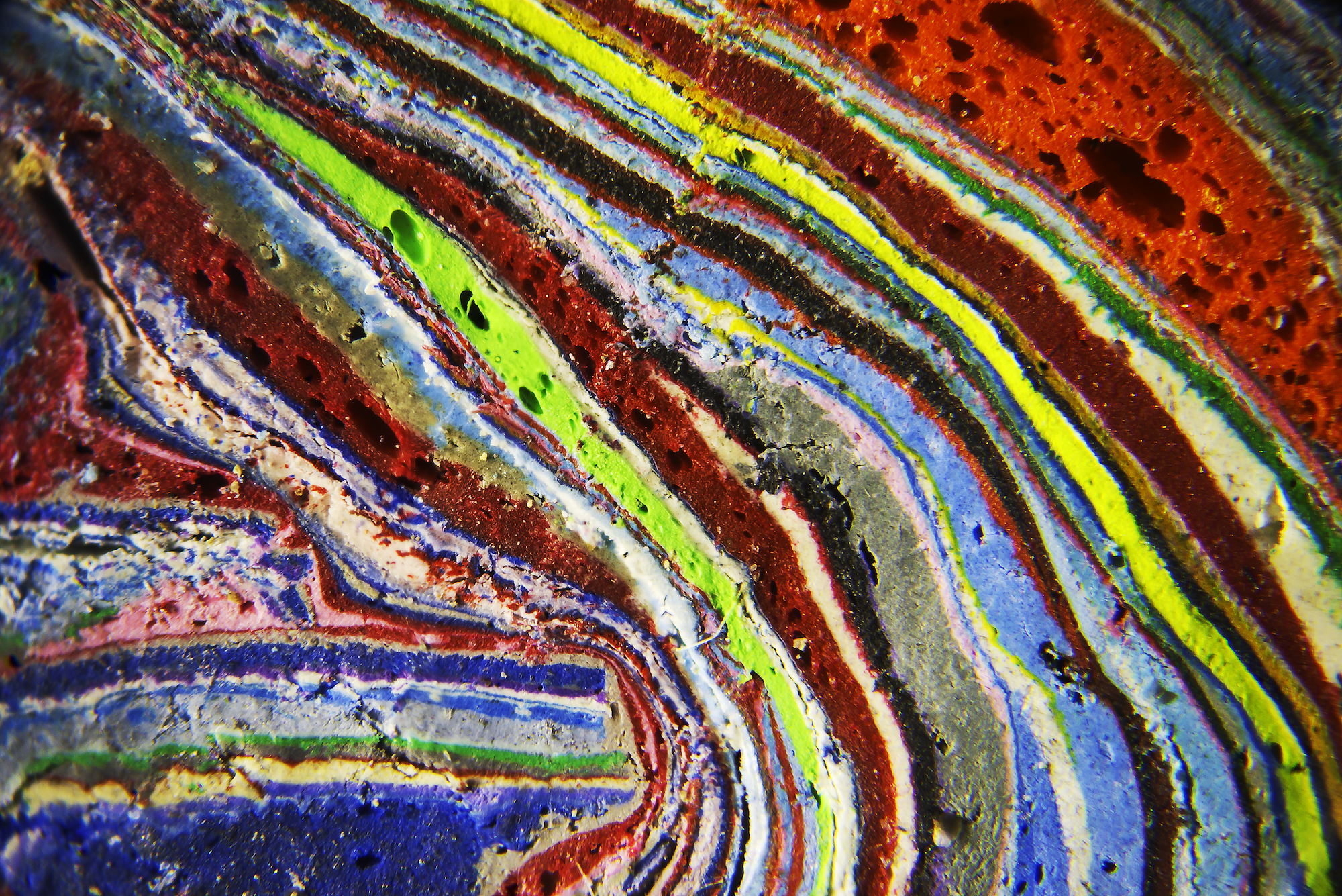 A cross section of paint layers seen under a microscope.