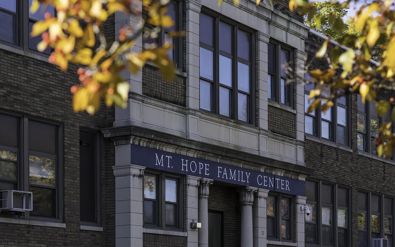 Outer facade of the Mt. Hope Family Center building with fall foliate in the foreground.